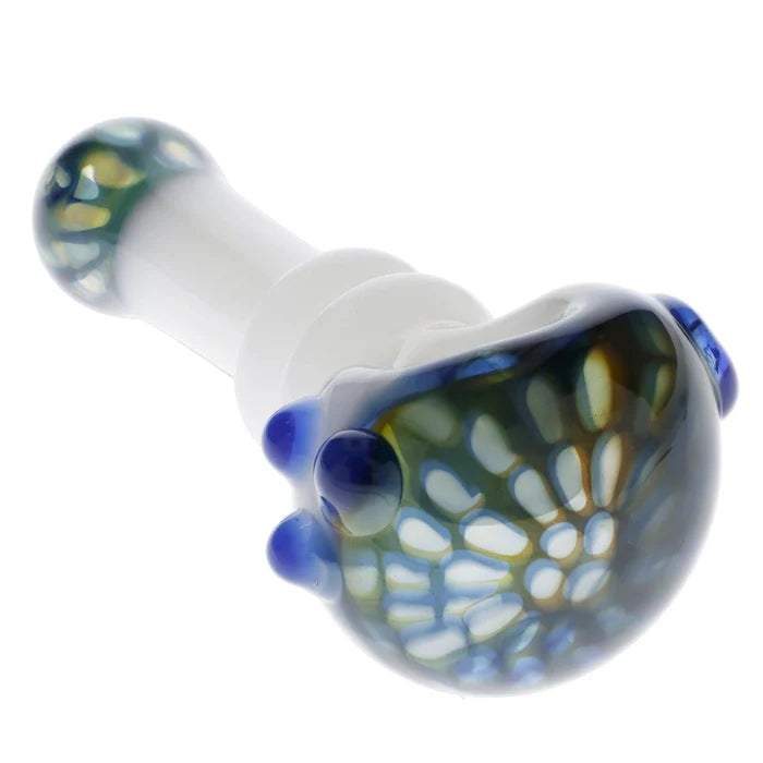 A close-up, angled view of the Valiant Wonderland Glass Pipe in white and blue, showcasing its curved shape and glass material.
