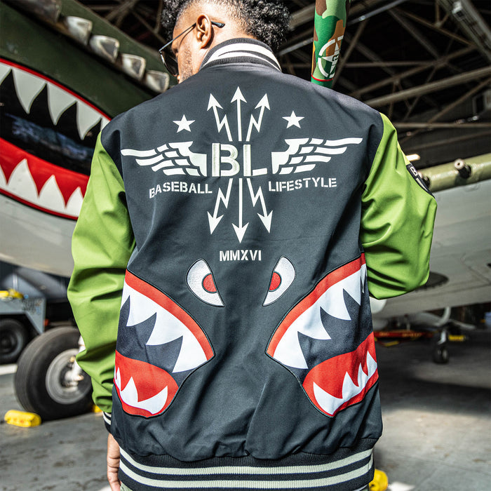 Adult model wearing black and army green Warhawk Bomber Jacket jacket