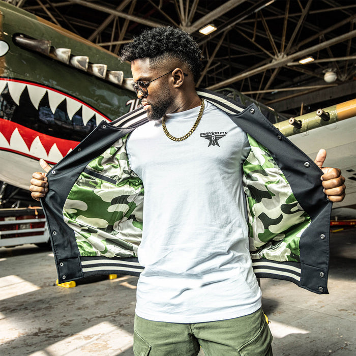 Adult model wearing black and army green Warhawk Bomber Jacket jacket