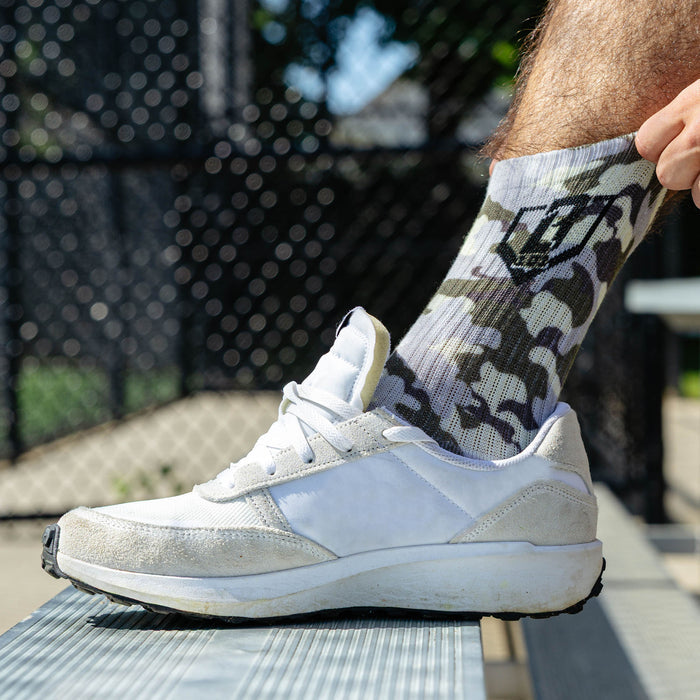 Adult model wearing green socks with "Warhawk Performance  3-Pack" design