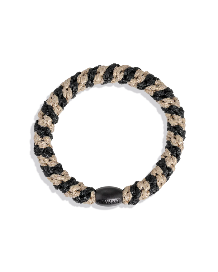 Woven glitter hair tie in black and beige with a dark oval center tag
