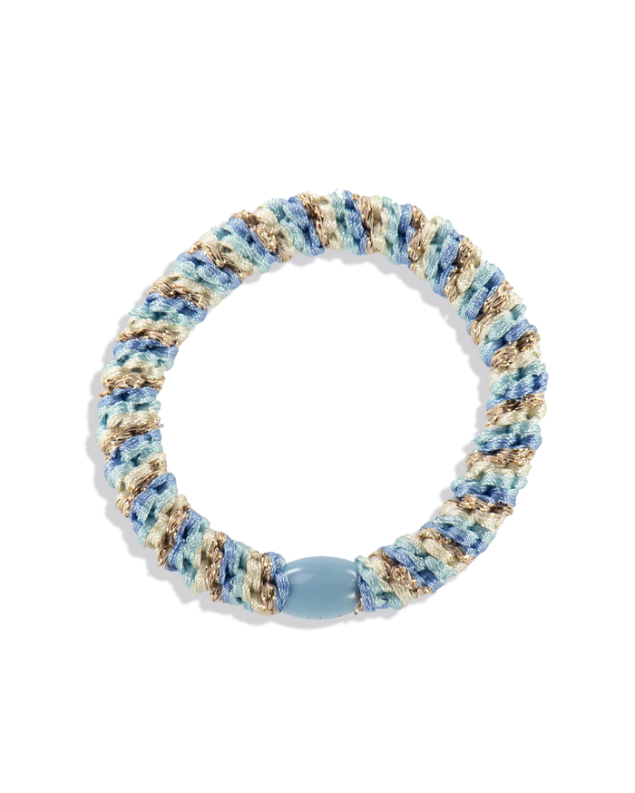 Woven glitter hair tie in light blue and beige with a pale blue center